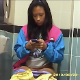 A mixed race girl is recorded by hidden camera as she plays with her cell phone and uses a toilet in a public restroom. No pooping sounds are heard, and she wipes from the front. Most likely pee only. About 2 minutes.